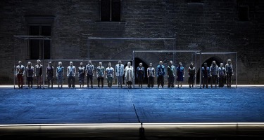 Line of people standing still facing forwards.