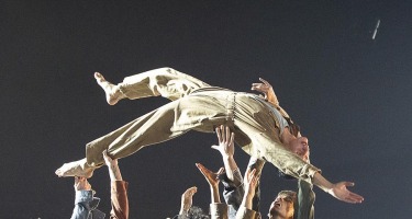 RUBBERBAND, Ever So Slightly. One dancer being hoisted by group of dancers.