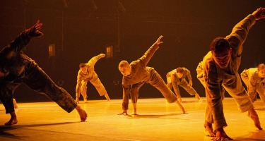 RUBBERBAND, Ever So Slightly. Group of dancers in coveralls.