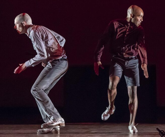 Dorrance Dance. SOUNDspace. Two men and two women, all in tight pants and solid colour tops, tap dance in a row. Two face the camera, and alternating between them two face to the left.