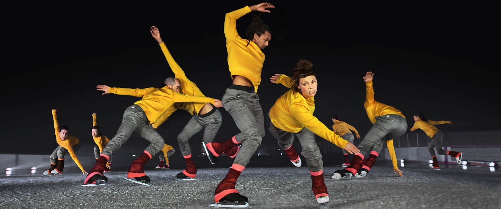 Le Patin Libre. A group of mixed gender figure skaters dressed in grey pants, yellow long sleeve tops and pink leg warmers skate in a loose group, reaching with their arms in various directions.
